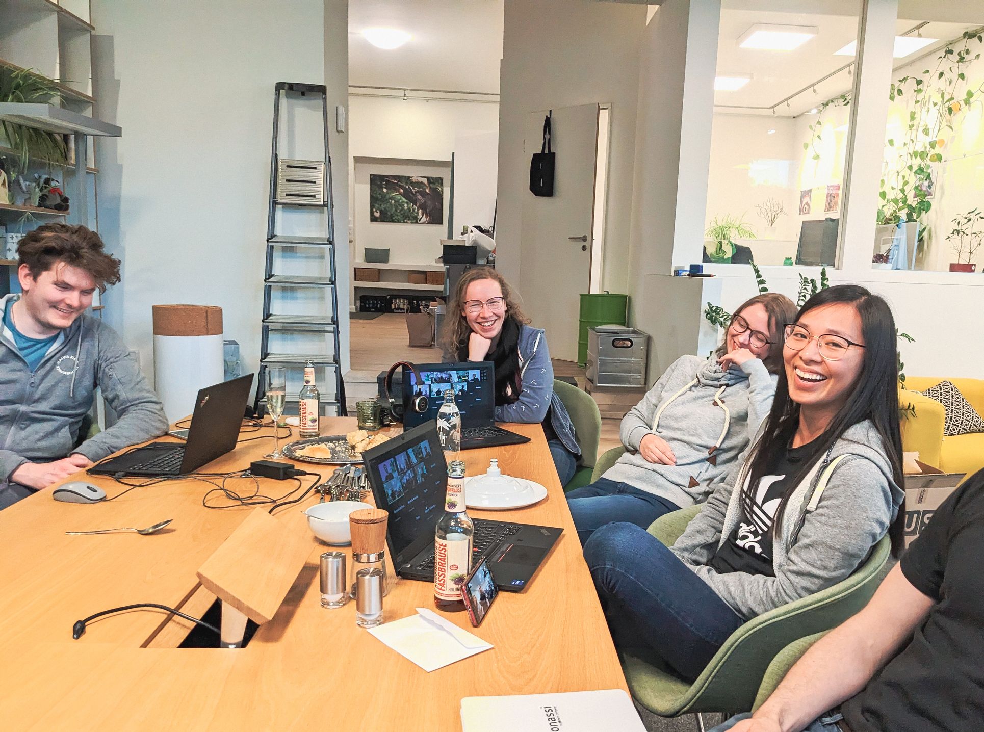 Our colleagues sitting on a table having a good time